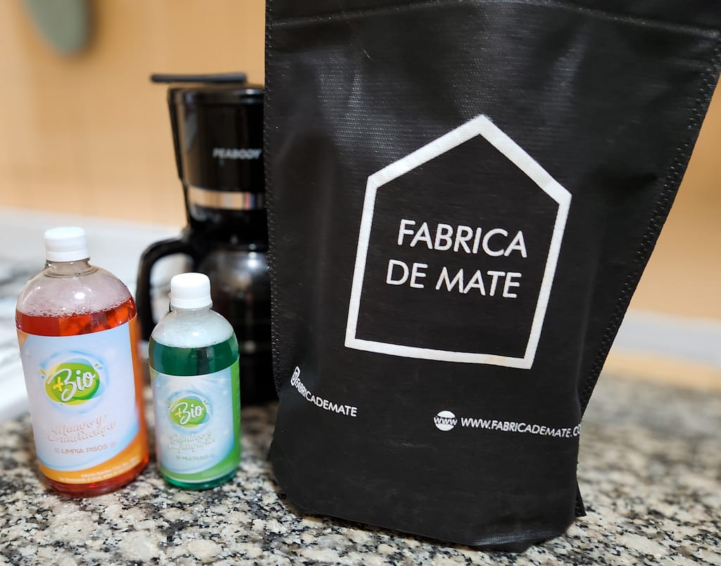 a bag next to bottles of cleaner