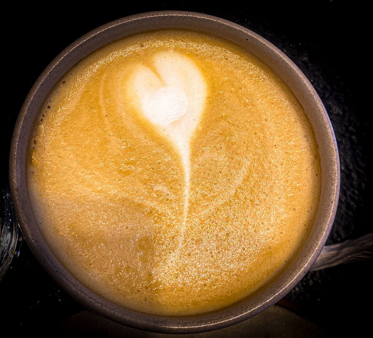 a coffee with a heart in the milk froth.