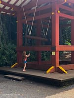 girl ringing large bell at Buddhist temple