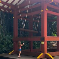 girl ringing large bell at Buddhist temple