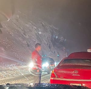 a man standing outside in the snow