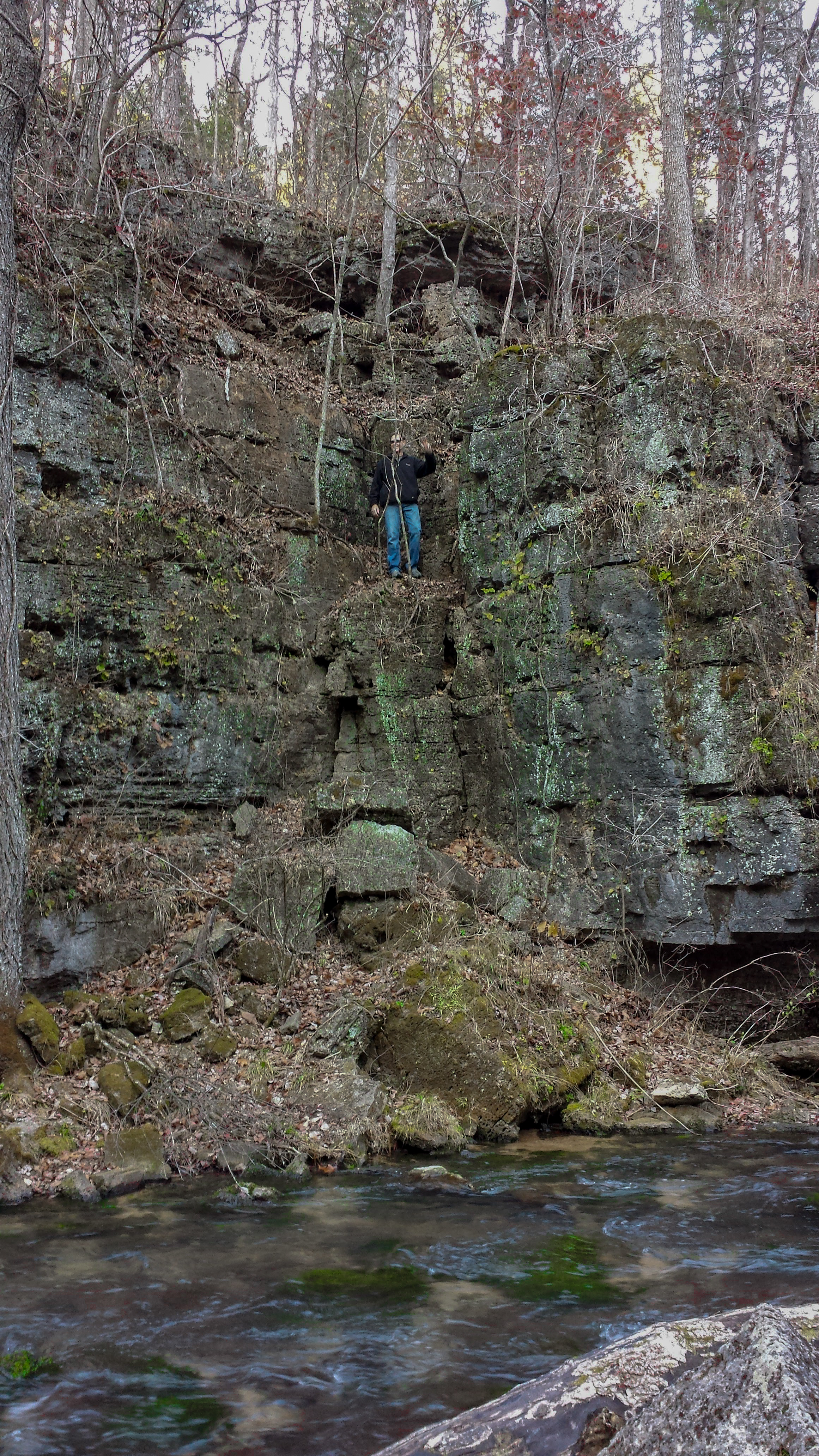 a man standing on rock cliff