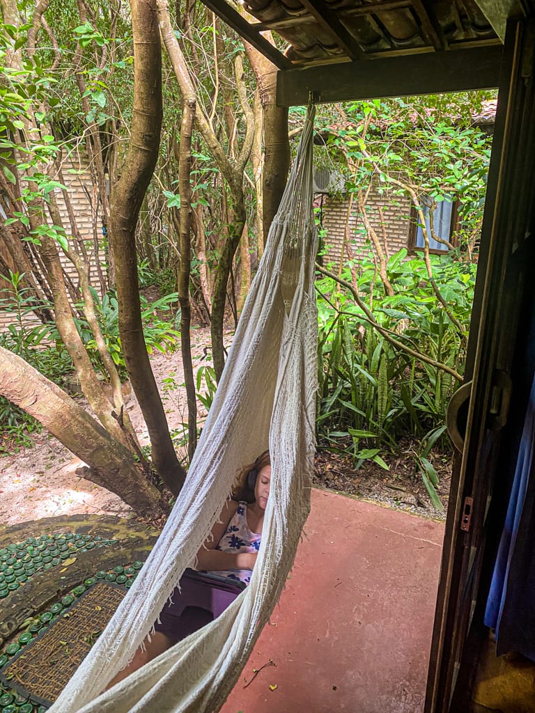 a girl in a hammock in a jungle