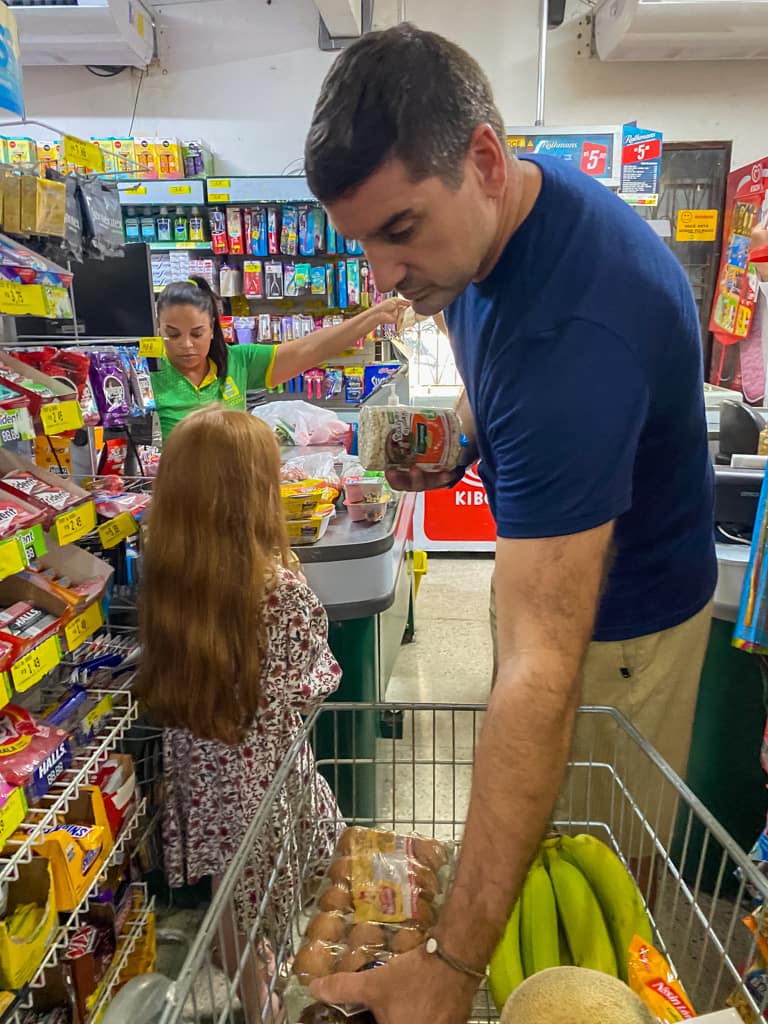 a man and daughter shopping in a grocery store in Brazil