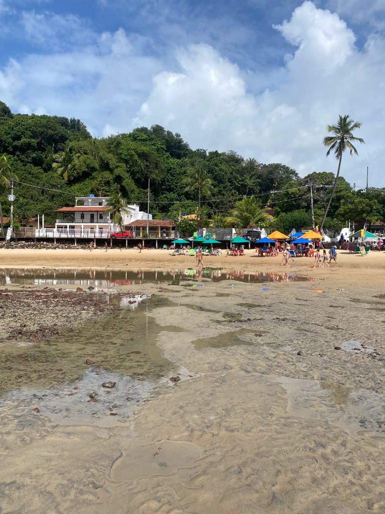 a view of beach side cafes from the water