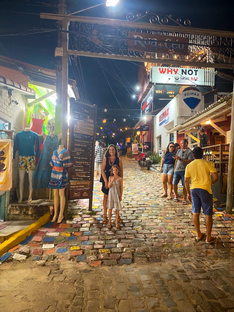 a woman and child on a multicolored brick road