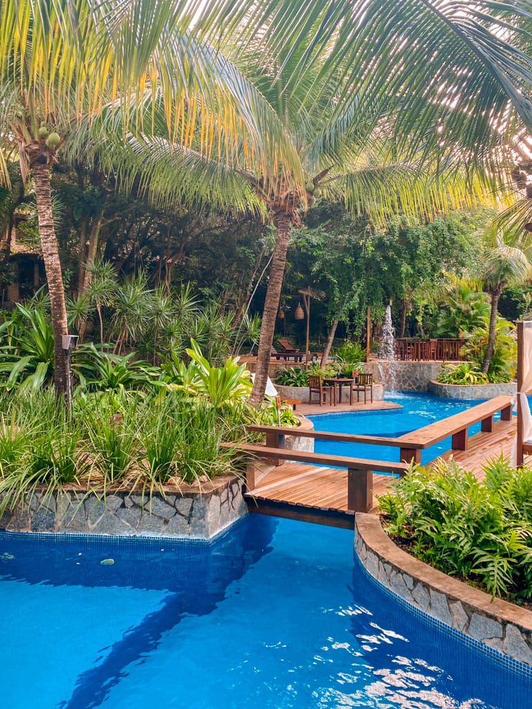 a pool with a bridge seperating areas