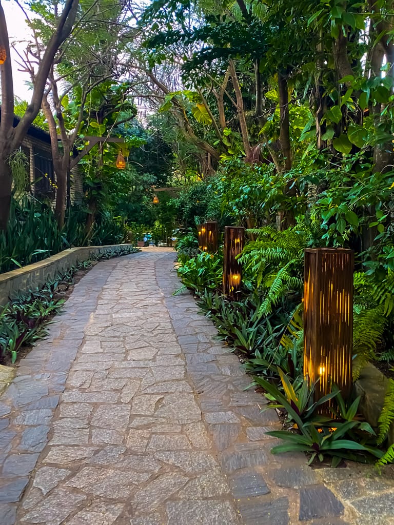 a stone walkway with dimly lit lights