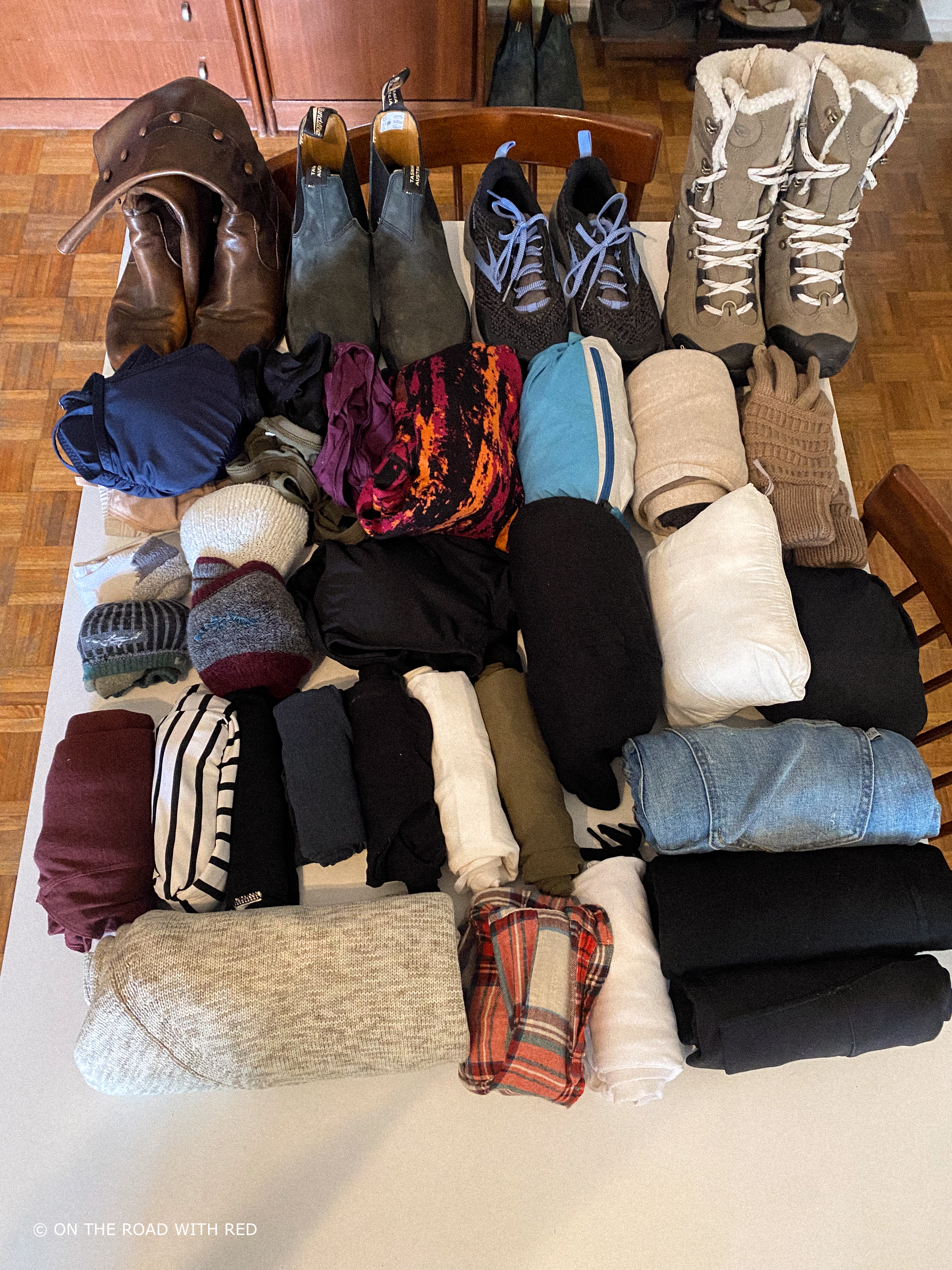 a table with a womens clothes ready to be packed