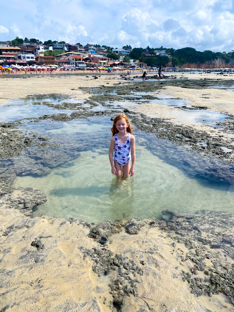 a child standing in a tide pool