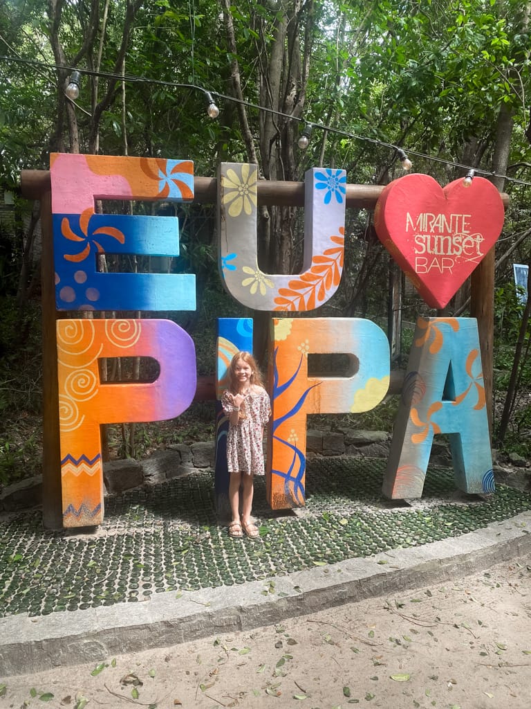 a child in front of an I love pipa sign