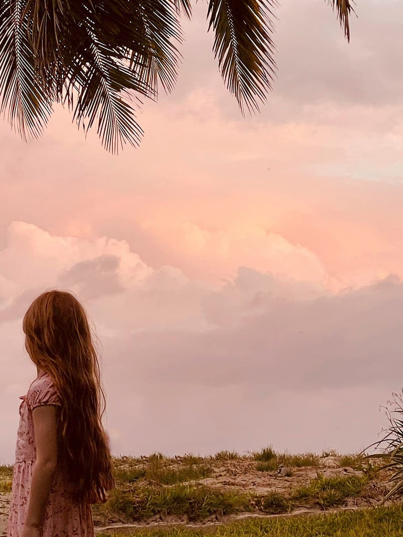 a girl looking at the sunset