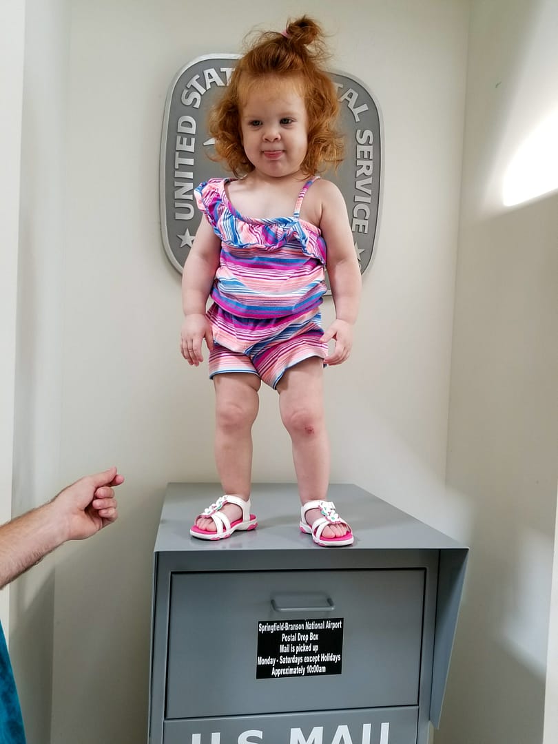 a child standing on a mailbox