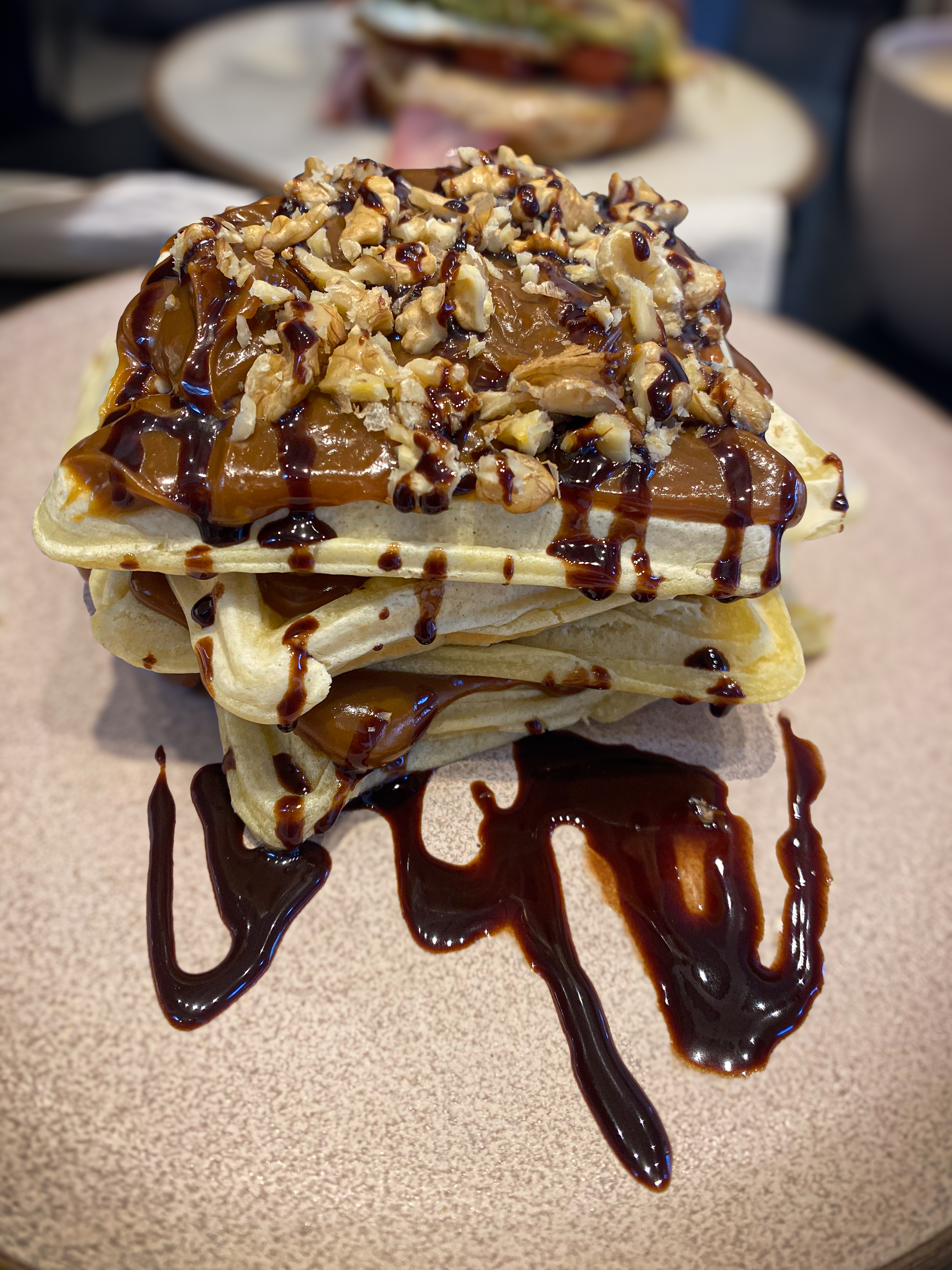 a stack of waffles covered in chocolate and dulce de leche.
