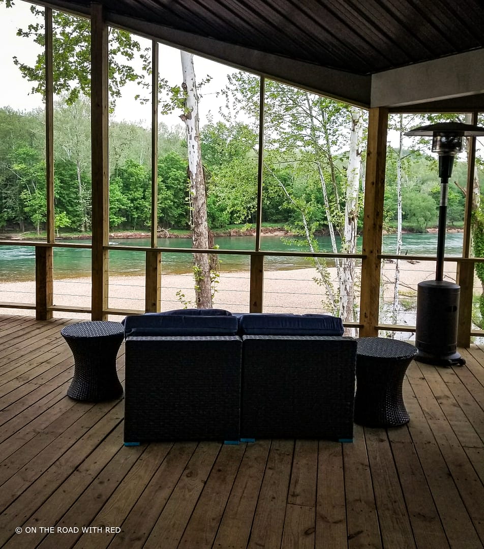 a view of the current river from a screen porch